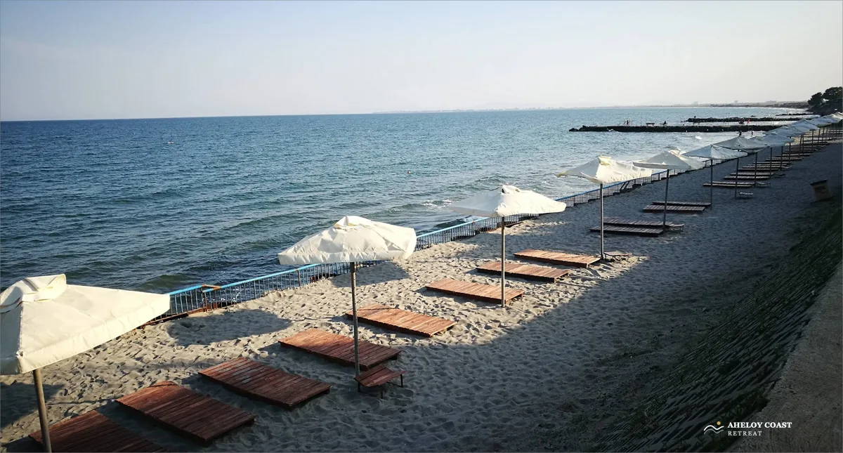 Aheloy beach with umbrellas and wooden sunbeds along the Black Sea shoreline