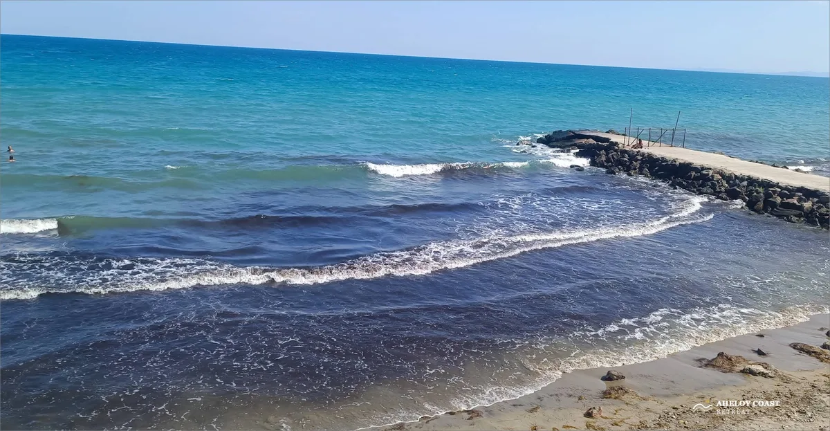 Turquoise Black Sea waves near the stone breakwater at Aheloy beach