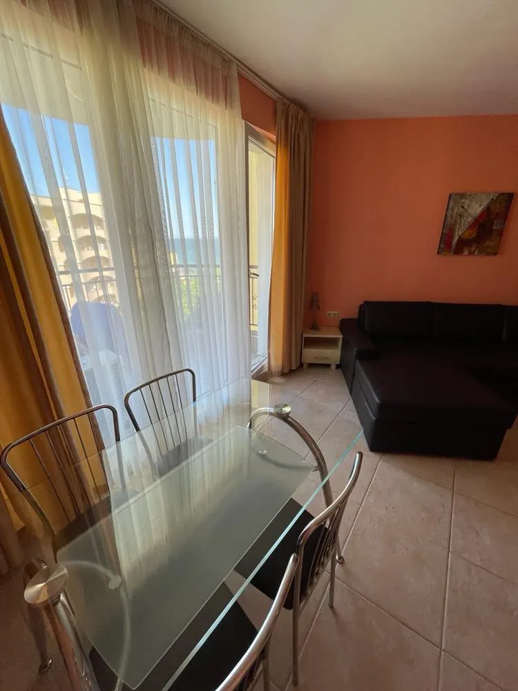 Dining table and sofa with sea-view balcony door