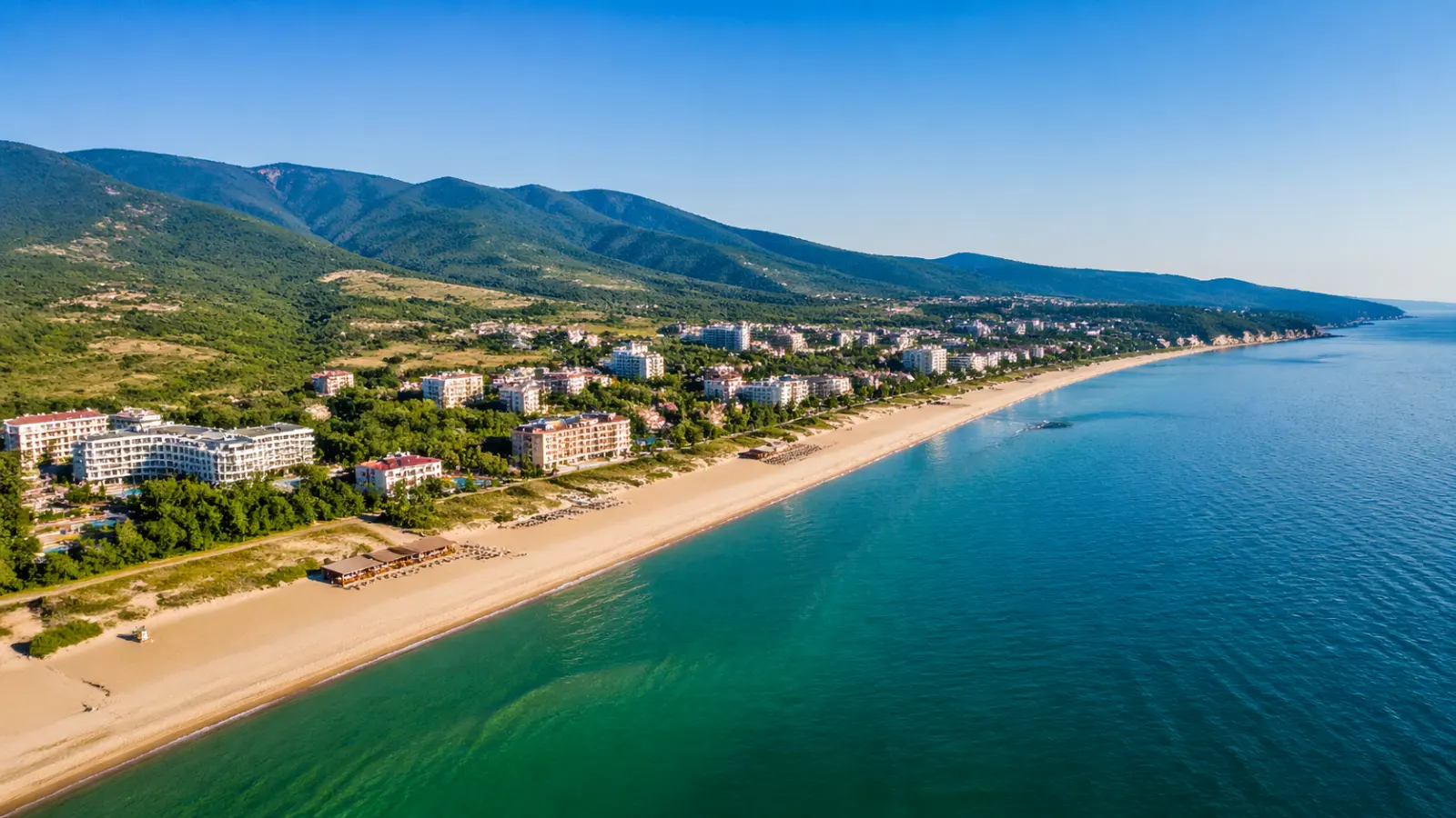Obzor beach and town on Bulgaria's Black Sea coast, with long sand, resort hotels, and hills behind the shore.