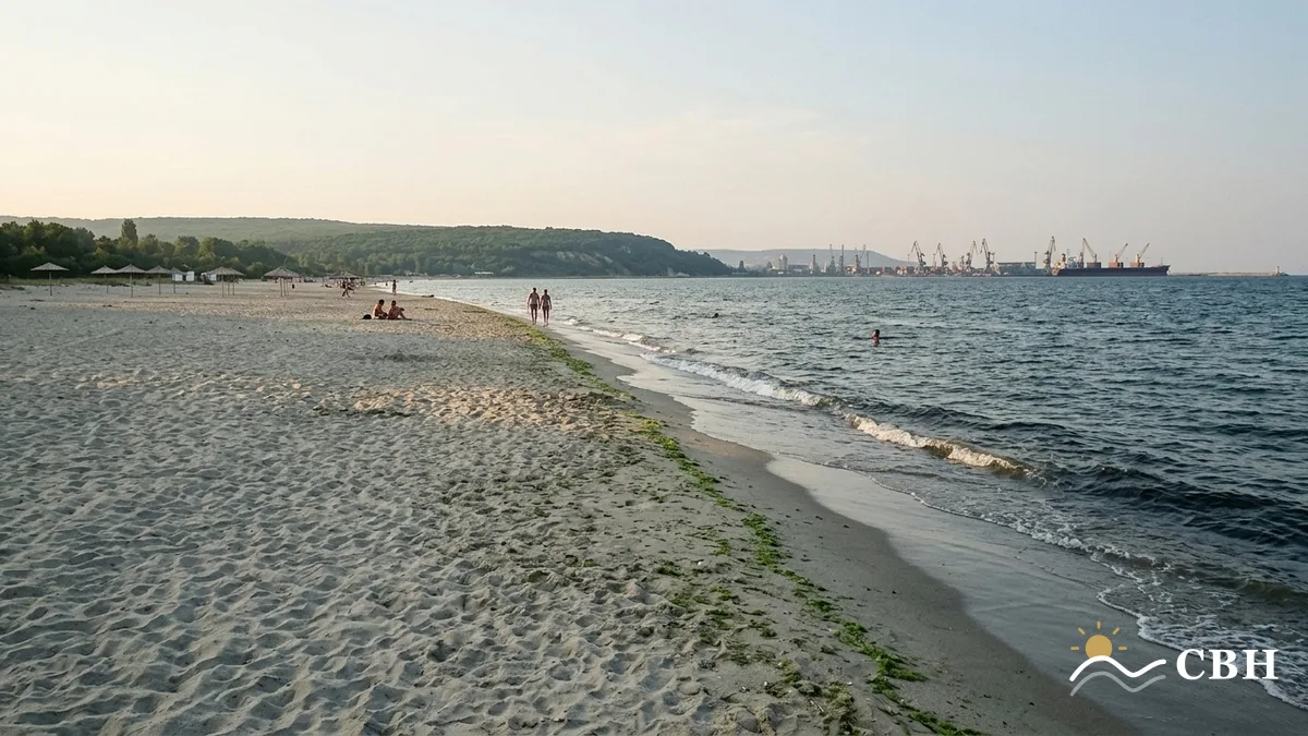 Asparuhovo beach across the bay from Varna, a wide flat expanse of sand with the port cranes visible on the far shore.